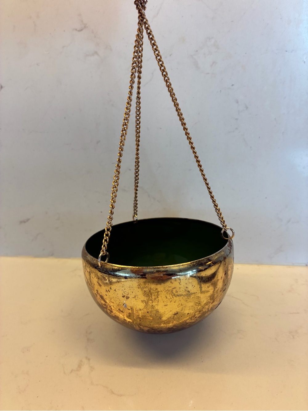 Vintage metal hanging planter bowl suspended by delicate metal chains.